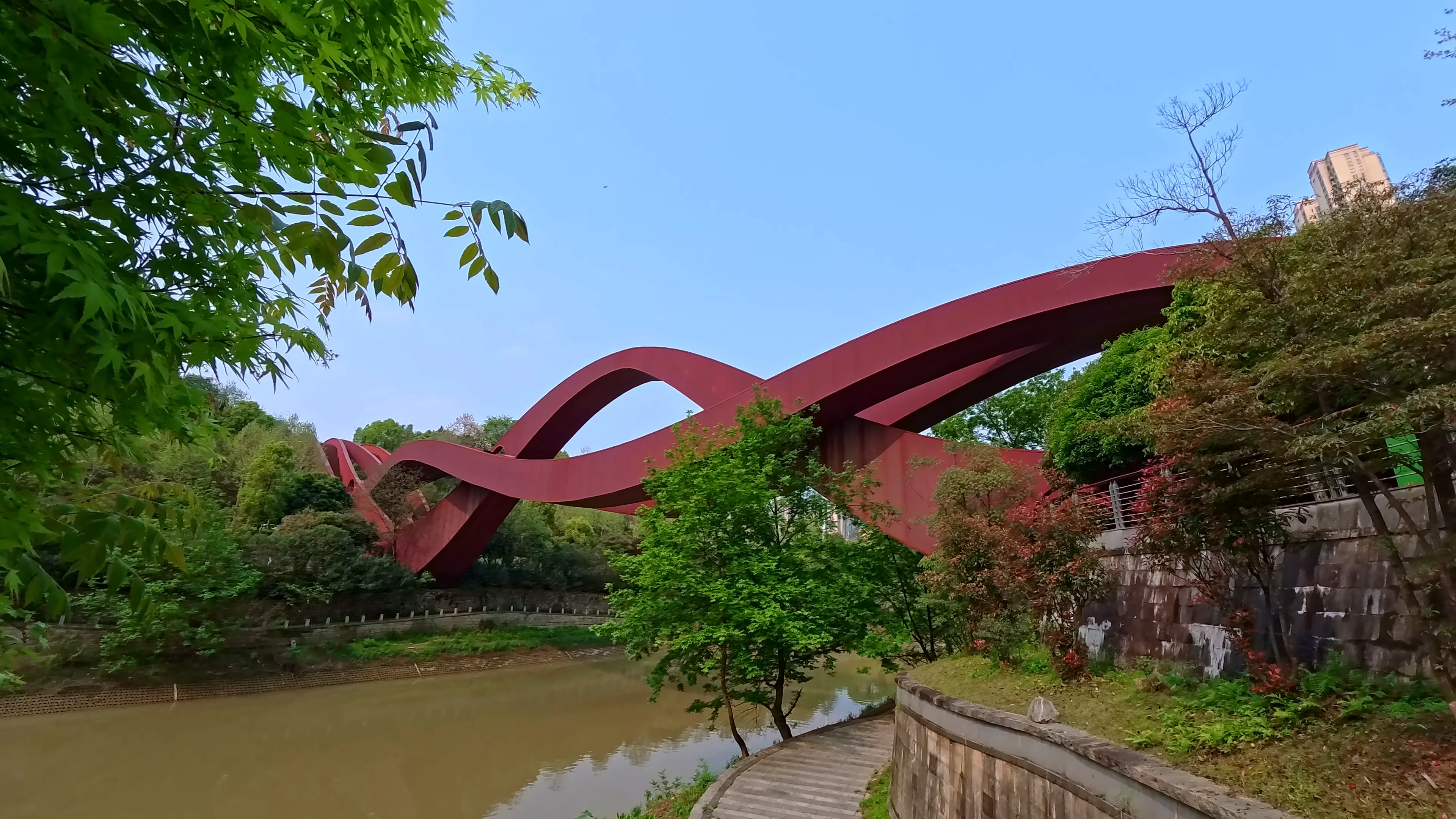 Peaceful lakeside walkway beneath soft overcast skies