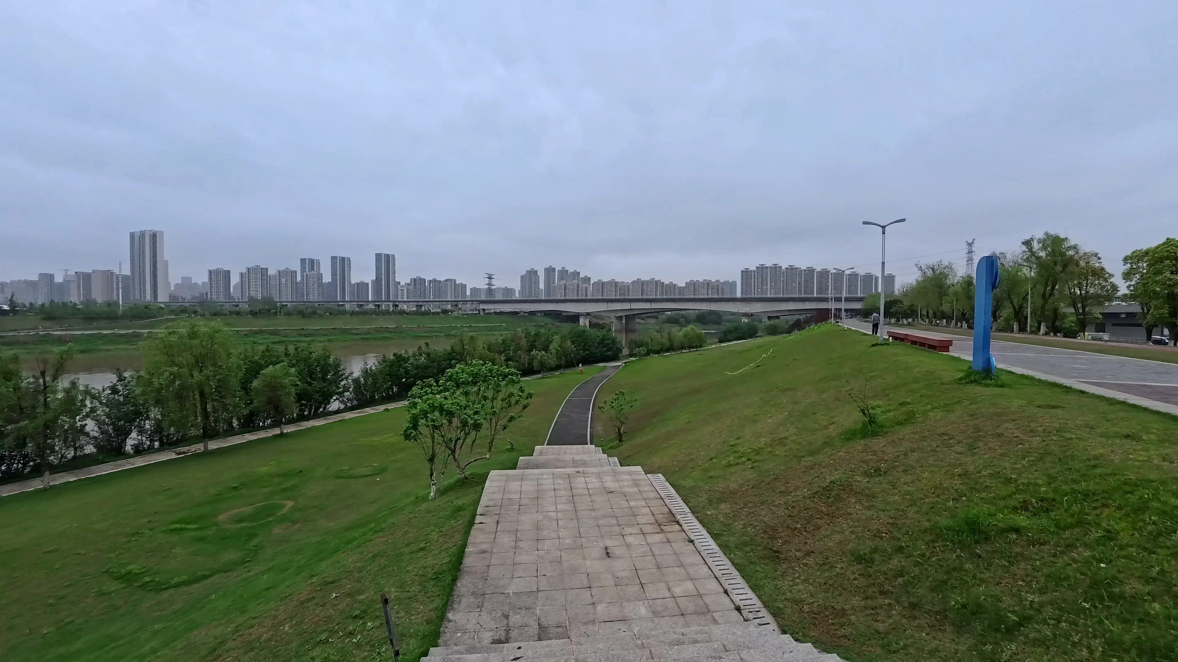 Wide riverside landscape beneath soft clouds