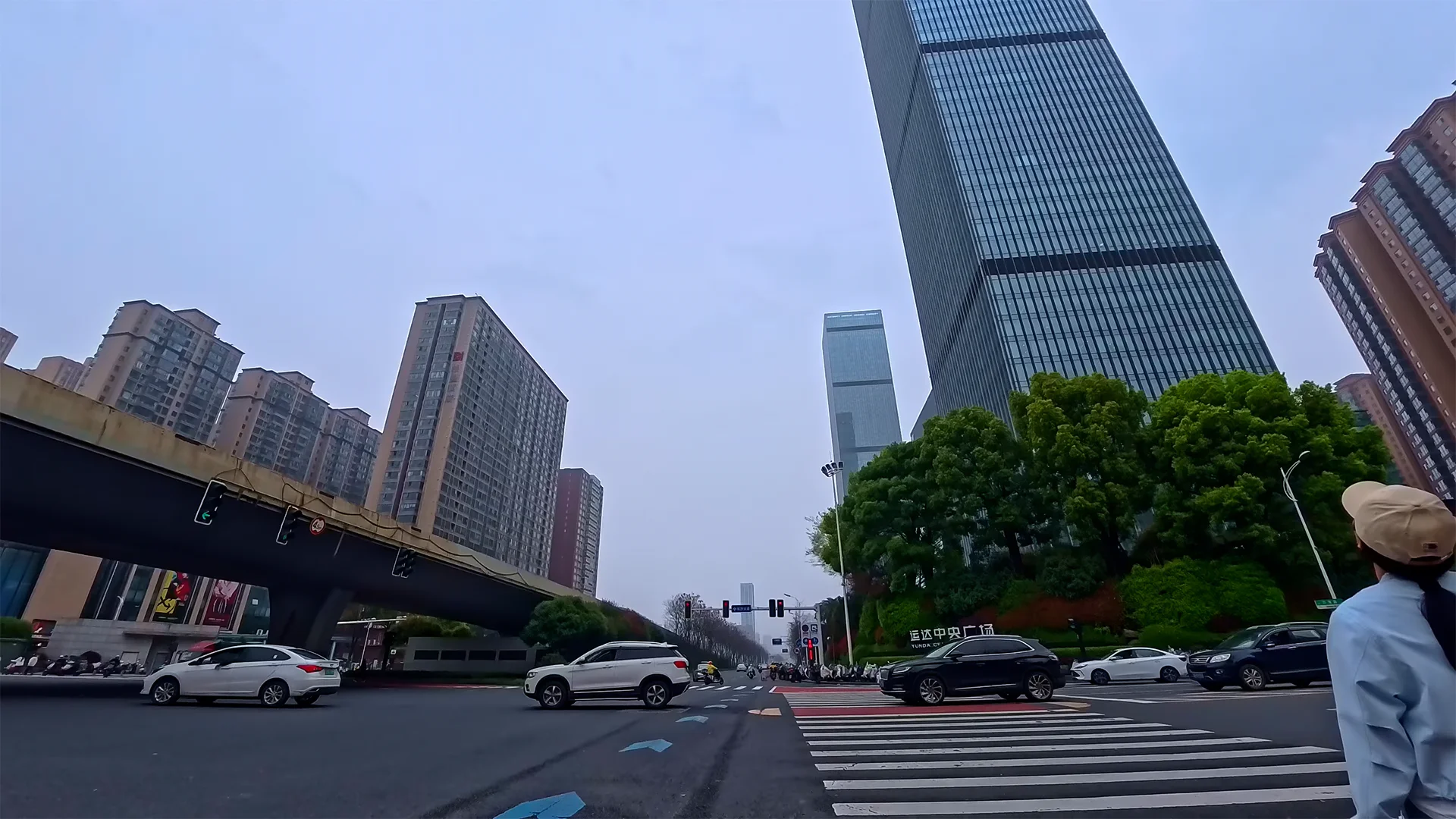 Wide urban intersection beneath gray skies